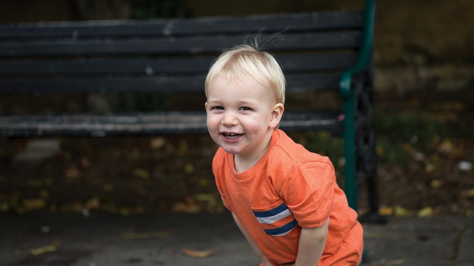 Smiling toddler in orange t shirt