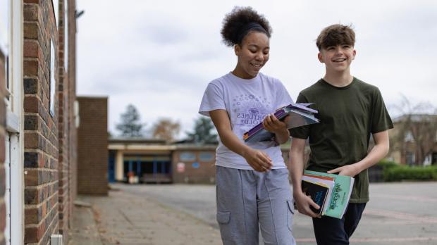  teenagers walk to college with their books