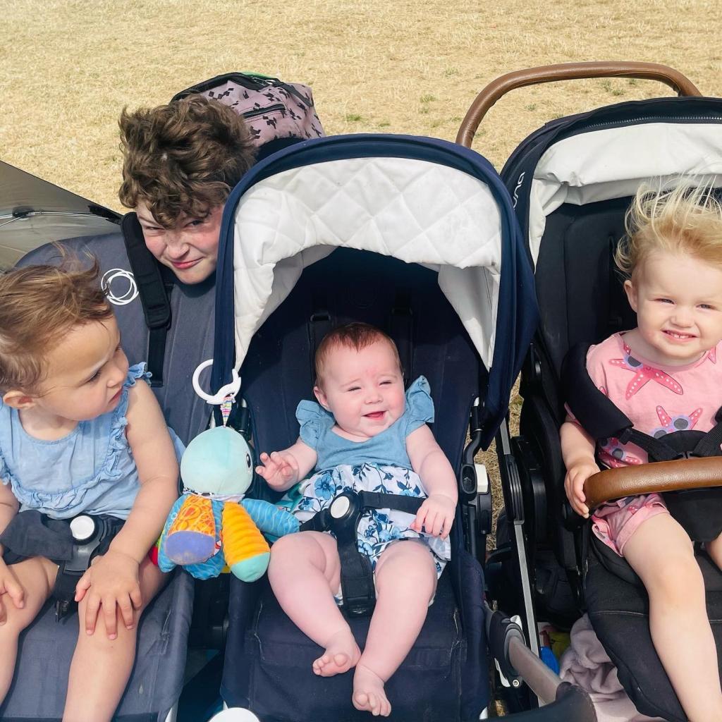 A group of children sitting in pushchairs