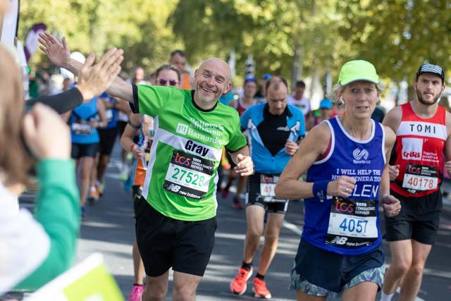 Graham, waves as he runs the London Marathon proudly in a Barnardo's jersey